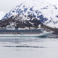 Alaska: The Last Frontier cruise ship surrounded by beautiful snowcapped mountains and water in glacier bay national park alaska