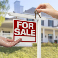 Real Estate Agent Handing over Keys to a House