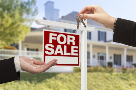 Real Estate Agent Handing over Keys to a House