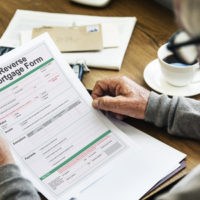 Elderly Man with Reverse Mortgage Form