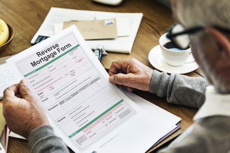 Elderly Man with Reverse Mortgage Form