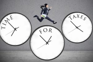 concept of time for taxes with a businesswoman running on watch