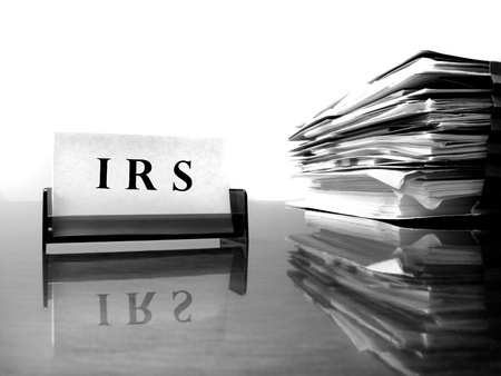 IRS card on Desk with Tax Files