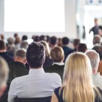 speaker giving a talk at a live seminar