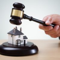 bidding on a home, gavel and house concept for home ownership, buying, selling or foreclosure