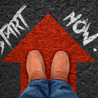 inspiration quote : " start now" on aerial view of shoe on road with move forward blue arrow ,motivational typographic.