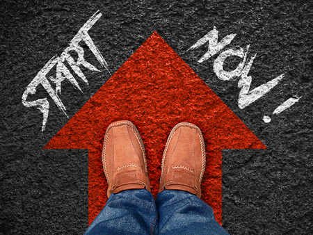 inspiration quote : " start now" on aerial view of shoe on road with move forward blue arrow ,motivational typographic.