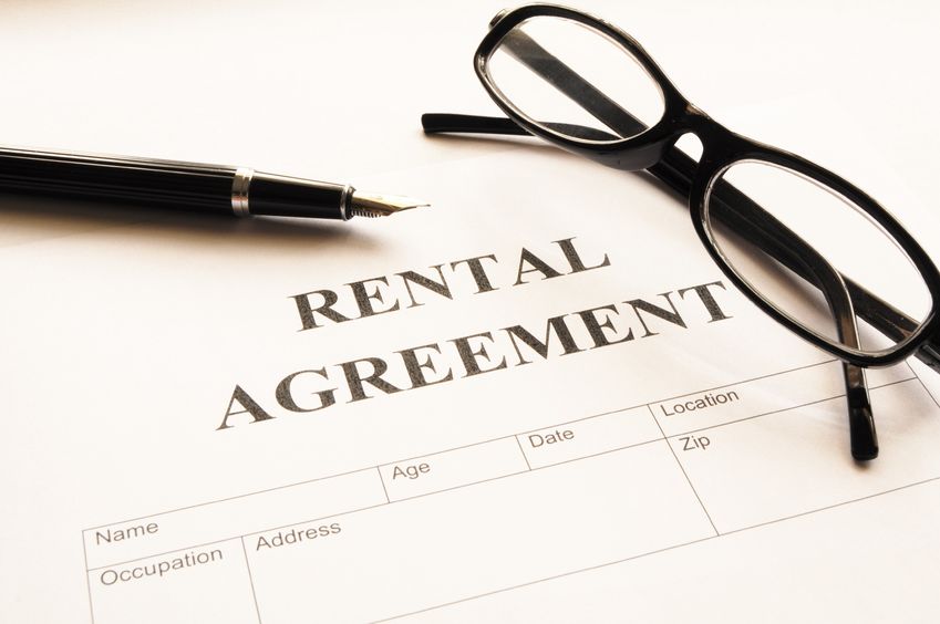 rental agreement form on desktop in business office showing real estate concept