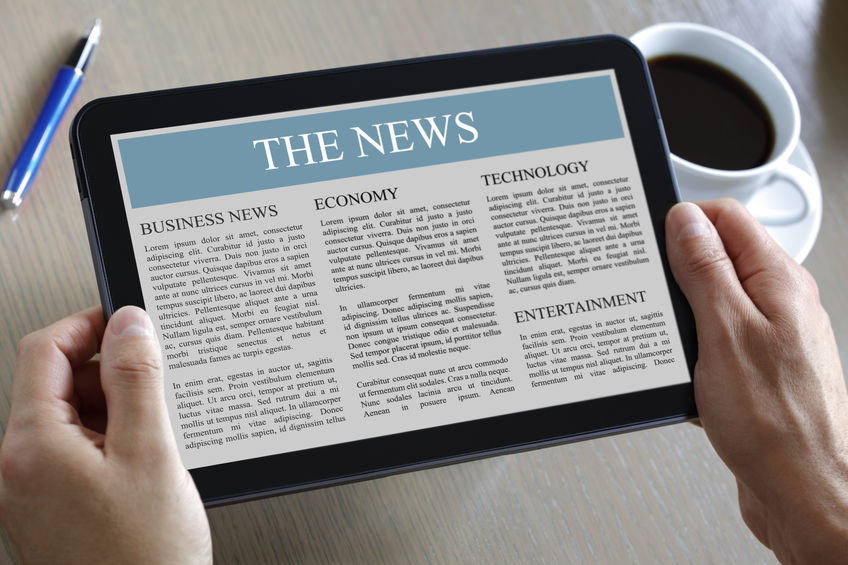 reading the news on a digital tablet