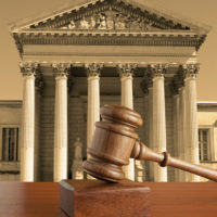 To Arbitrate Or Not To Arbitrate, That Is The Question gavel against the background of the courthouse