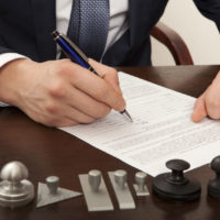 lawyer, notary signs the documents from our office