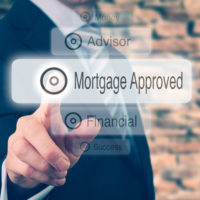 Businessman pressing a Mortgage Loan Approval concept button.
