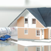 2019 HOME BUYERS CAPITALIZE ON A SHIFTING MARKET Real Estate Concept - Miniature Model House on Top of a Glass Table with Calculator, Keys and Blueprint.