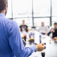Special for MLO CE Sign-Ups During October Business man making a presentation at office. Business executive delivering a presentation to his colleagues during meeting or in-house business training, explaining business plans to his employees.