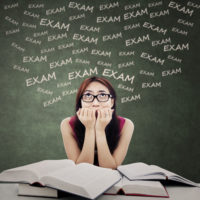 Portrait of female student biting her nail and feel nervous to face exam