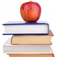 30418607 - wisdom apple on few school books isolated on a white background