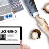 Patent License agreement LICENSING   business man hand working on laptop computer