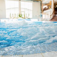 Waves and splashes in warm spa jacuzzi with nobody around