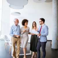 Group of successful business people standing in the modern office